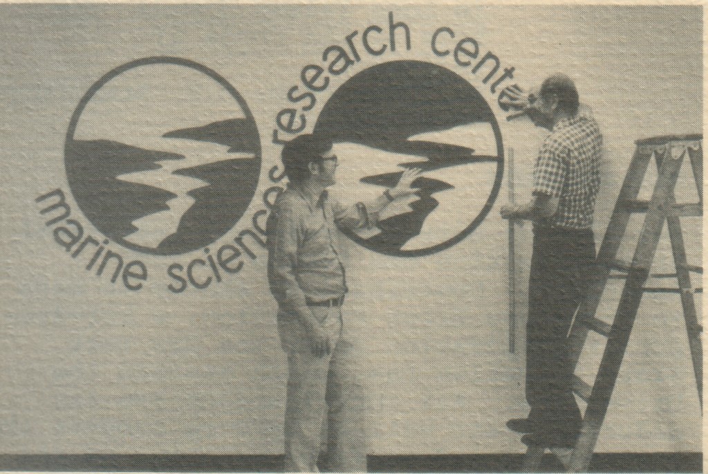 MSRC's logo is prominently displayed in Endeavour Hall. Former director J. R. Schubel, left, enlisted the services of his father-in-law, Dr. Marion Hostetler, Montpelier, Ohio, in the execution of the design. The logo consists of reduplicated circles depicting an estuary emptying into the ocean. The circle on the left is green, representing land and vegetation, while the one on the right is blue, representing the estuary and the sea. The logo graphically depicts MSRC's commitment to the coastal environment. 