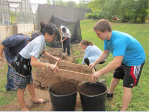 Students sifting soil for use in an experiment.
